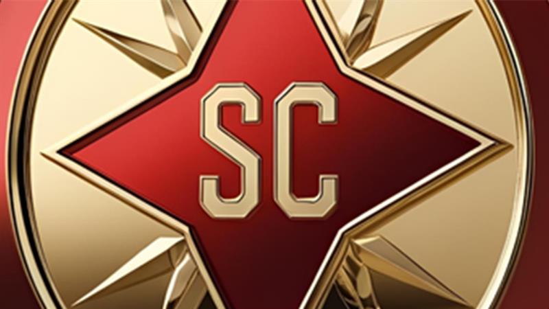 A gold and red coin featuring a red star at its center with the letters "SC" in bold, stylized font.